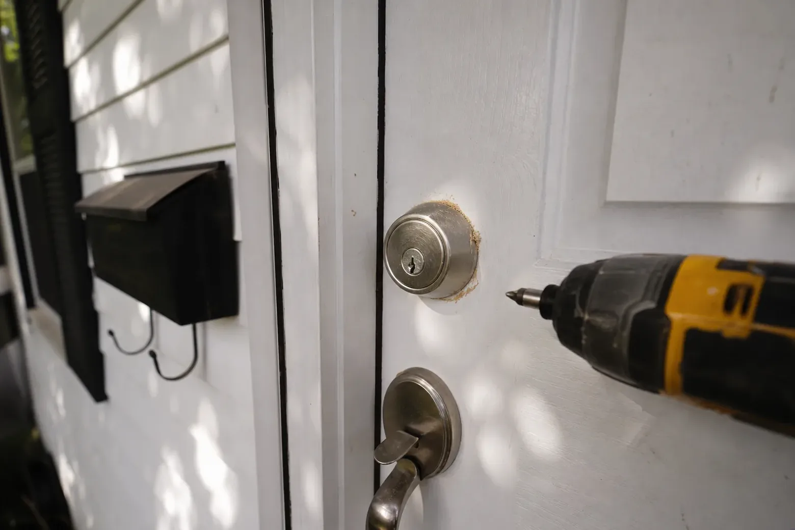 New deadbolt being installed in a front door